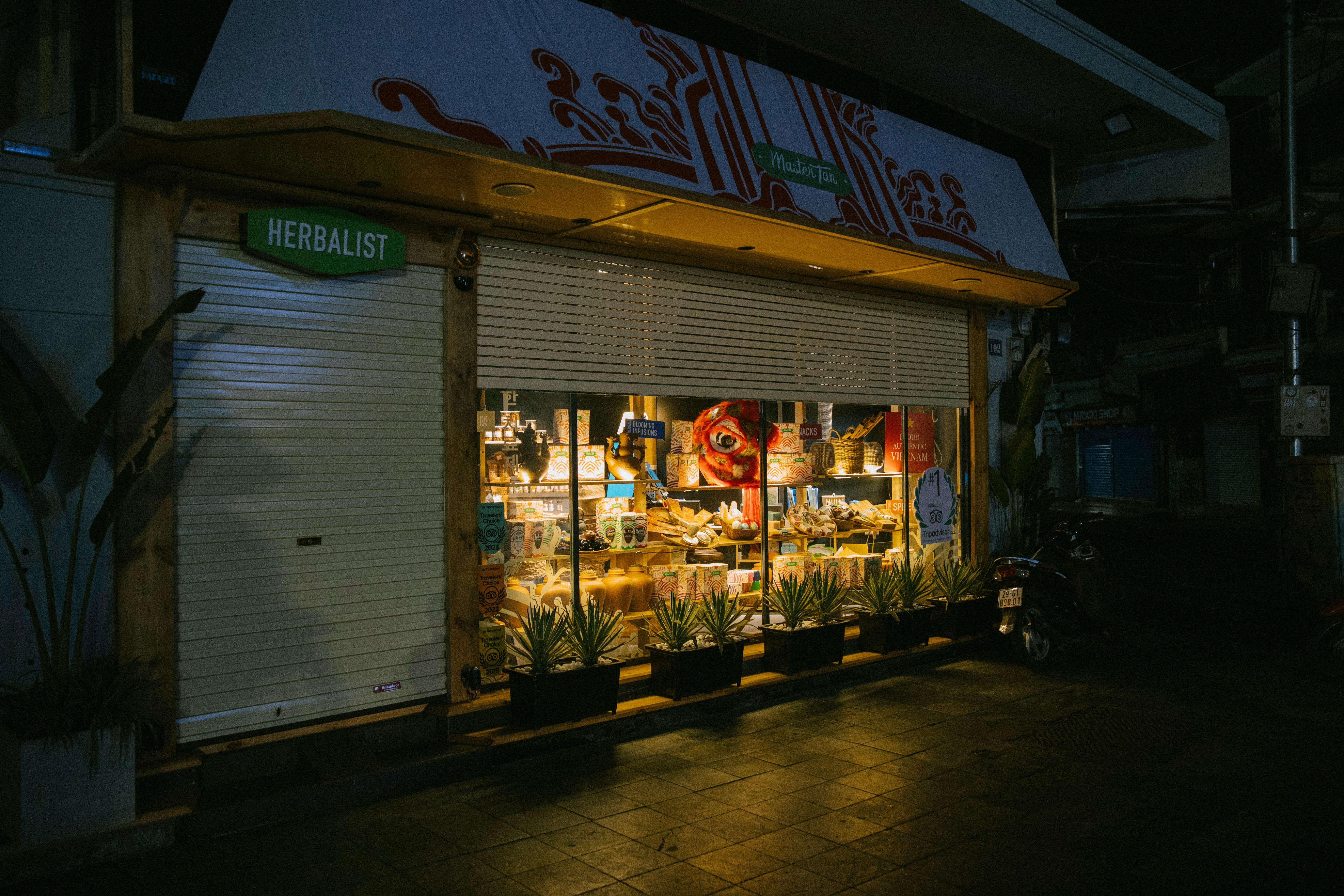 [Exterior view of a traditional pharmacy storefront on a leafy residential street in Wigston, Leicestershire]